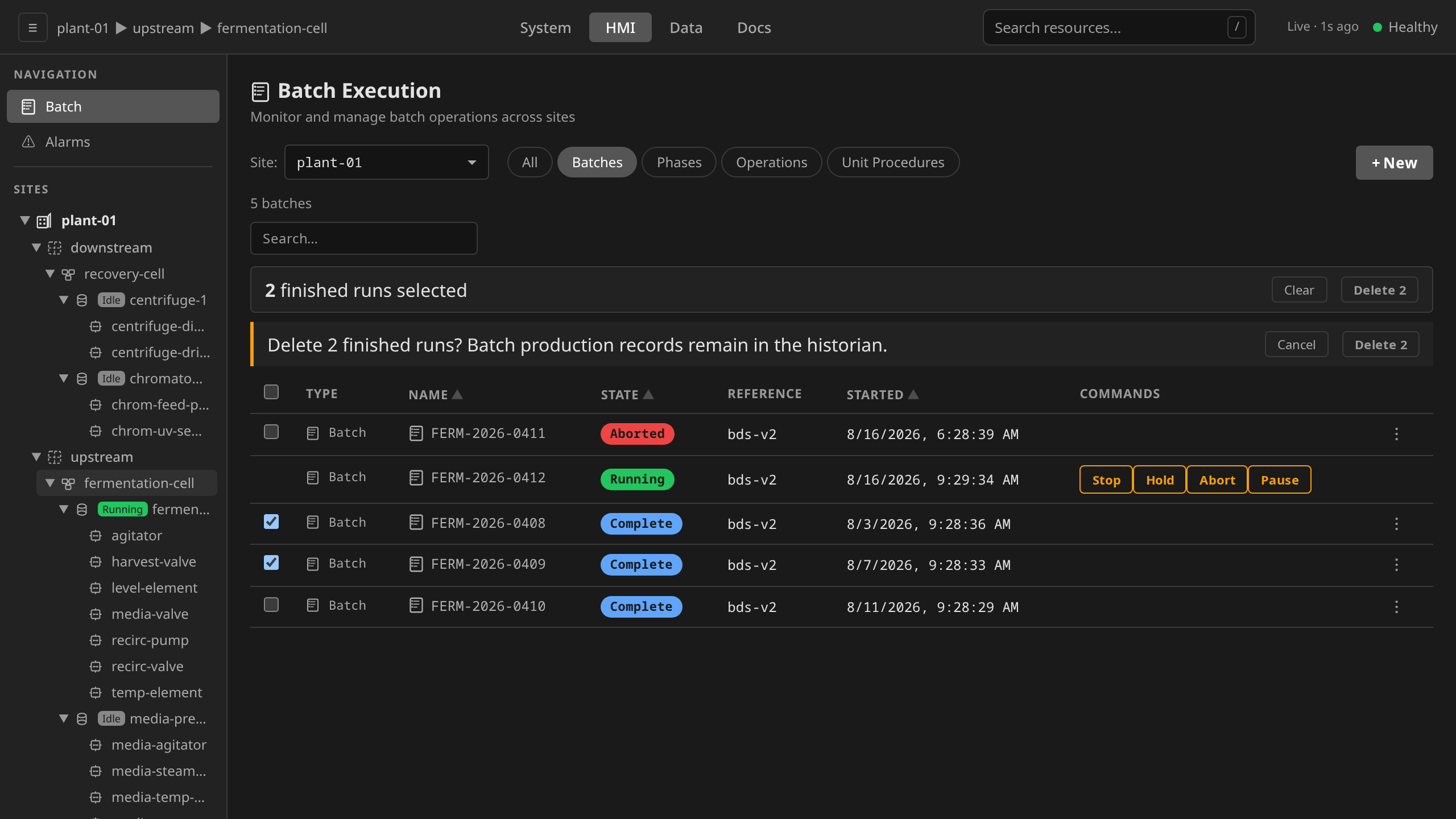 Bulk cleanup: two finished runs selected, the selection bar counting them, and the single confirm that disposes of both